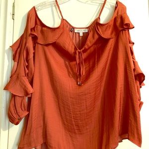 Women’s rust colored top with cold shoulders